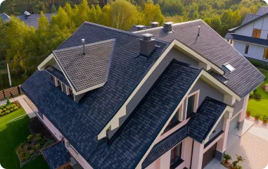 Aerial view of a dark shingle roof on a large house