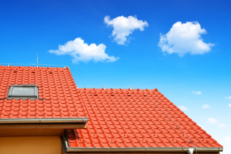 Roof,House,With,Tiled,Roof,On,Blue,Sky.