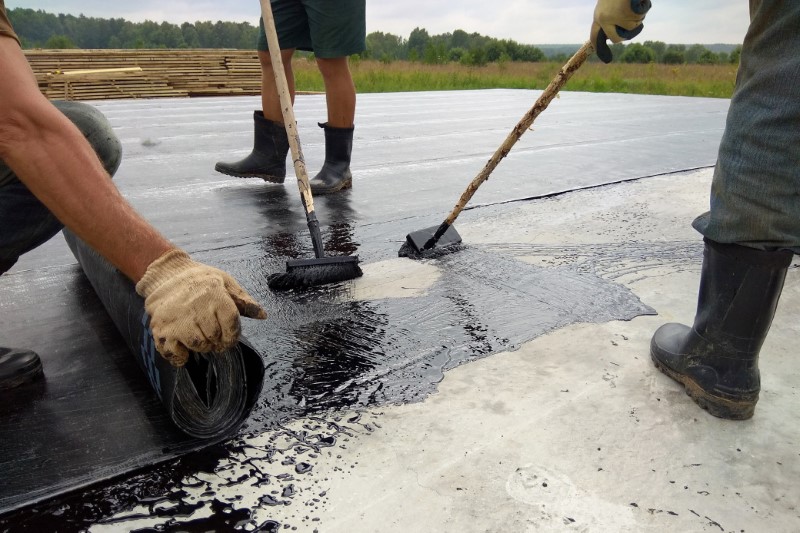 Roofer,Worker,Painting,Bitumen,Praimer,At,Concrete,Surface,By,The